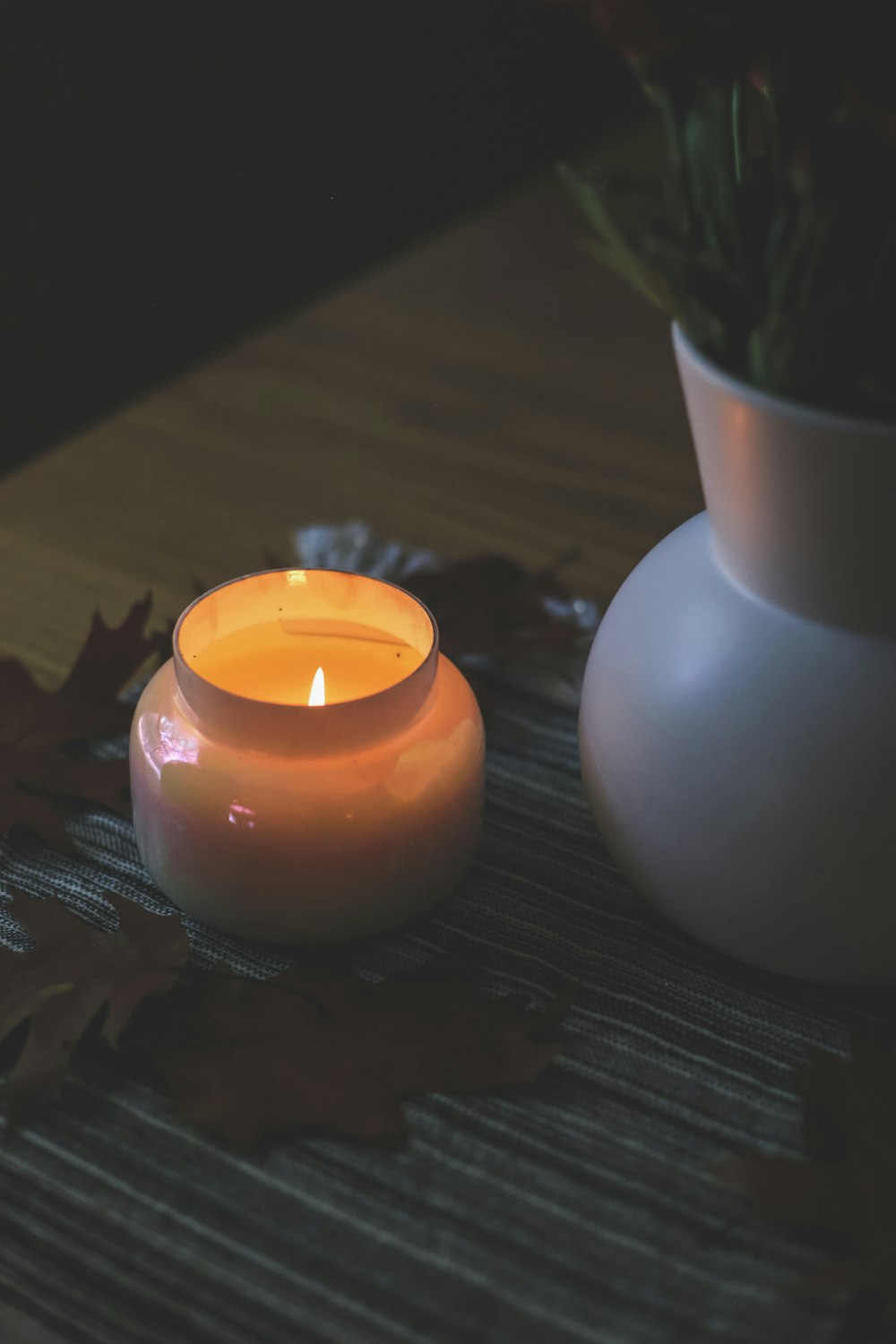 white candle holder with orange candle