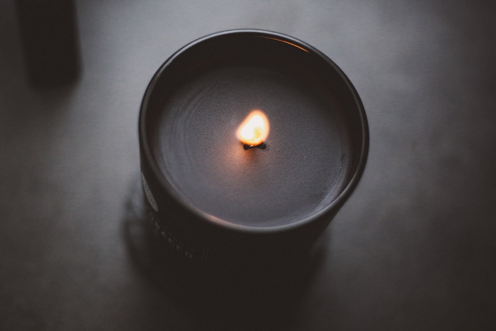 black candle holder with lighted candle