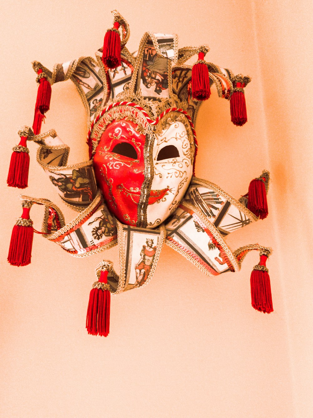 white and red mask on white wall