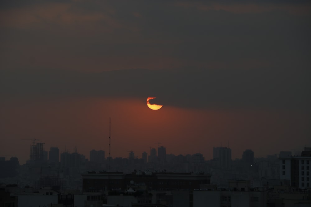 silhouette of city buildings during sunset