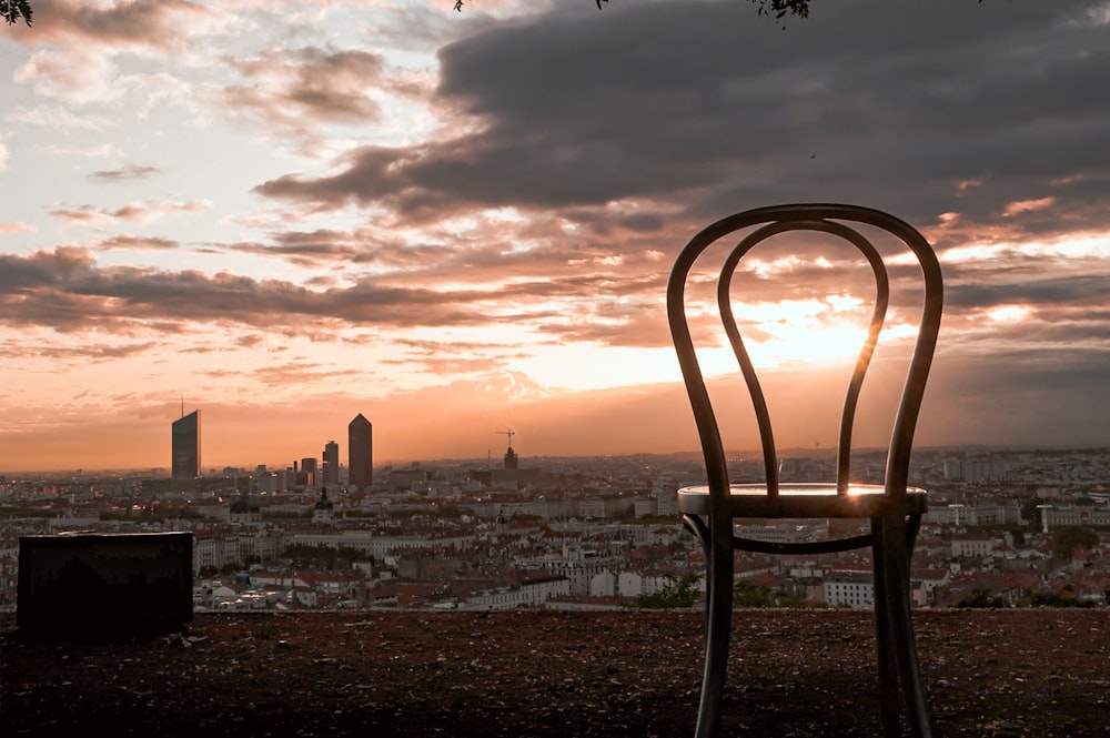 brown wooden chair on beach during sunset