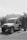 A rugged off-road vehicle with the words 'Pink Jeep Tours' on its side is parked in an outdoor setting. The background features a mountainous landscape under a clear sky. The environment suggests a location suitable for adventure and exploration.