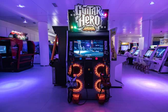 a video game machine with neon lights in a room