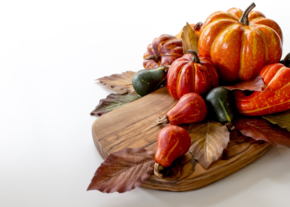 orange and green vegetable on brown wooden round plate