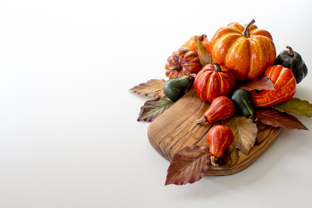 orange and green vegetables on brown wooden chopping board