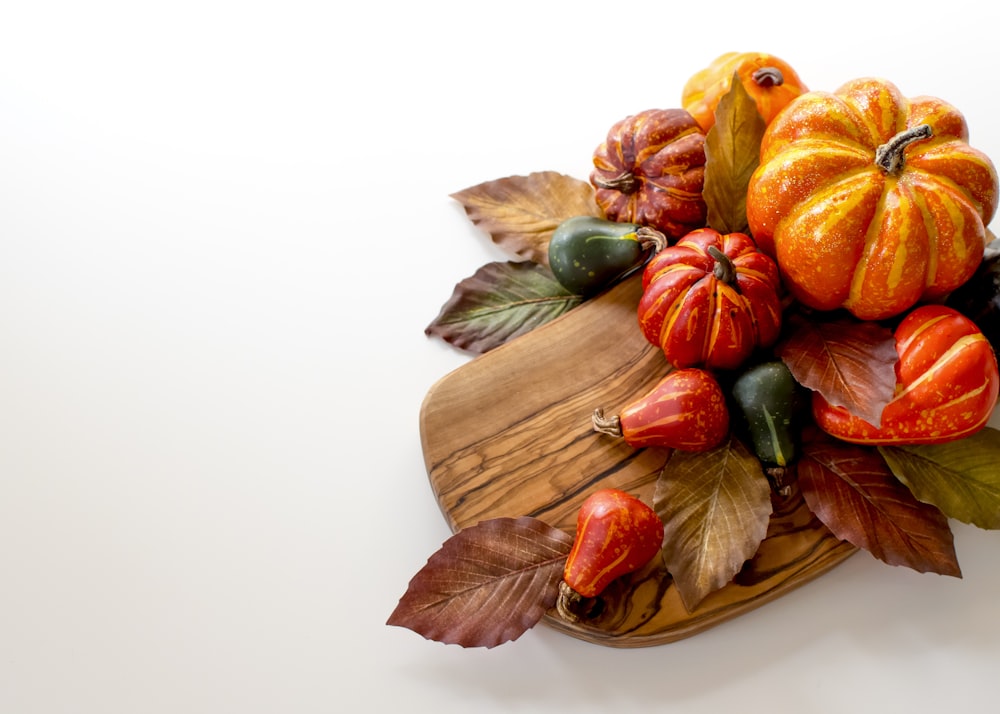 orange and green vegetables on brown wooden chopping board