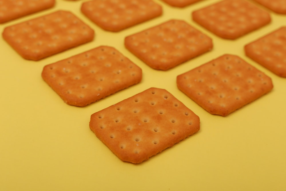 brown biscuits on yellow surface