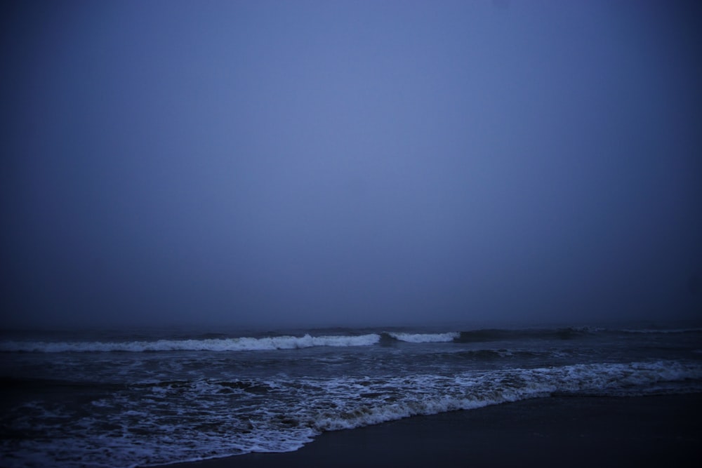 ocean waves crashing on shore during daytime