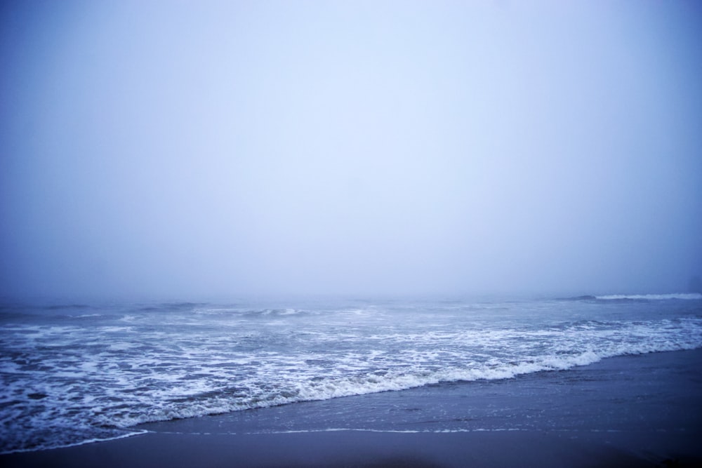 ocean waves crashing on shore during daytime