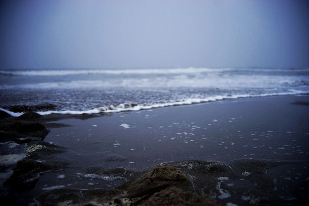 brown rock formation on sea shore during daytime