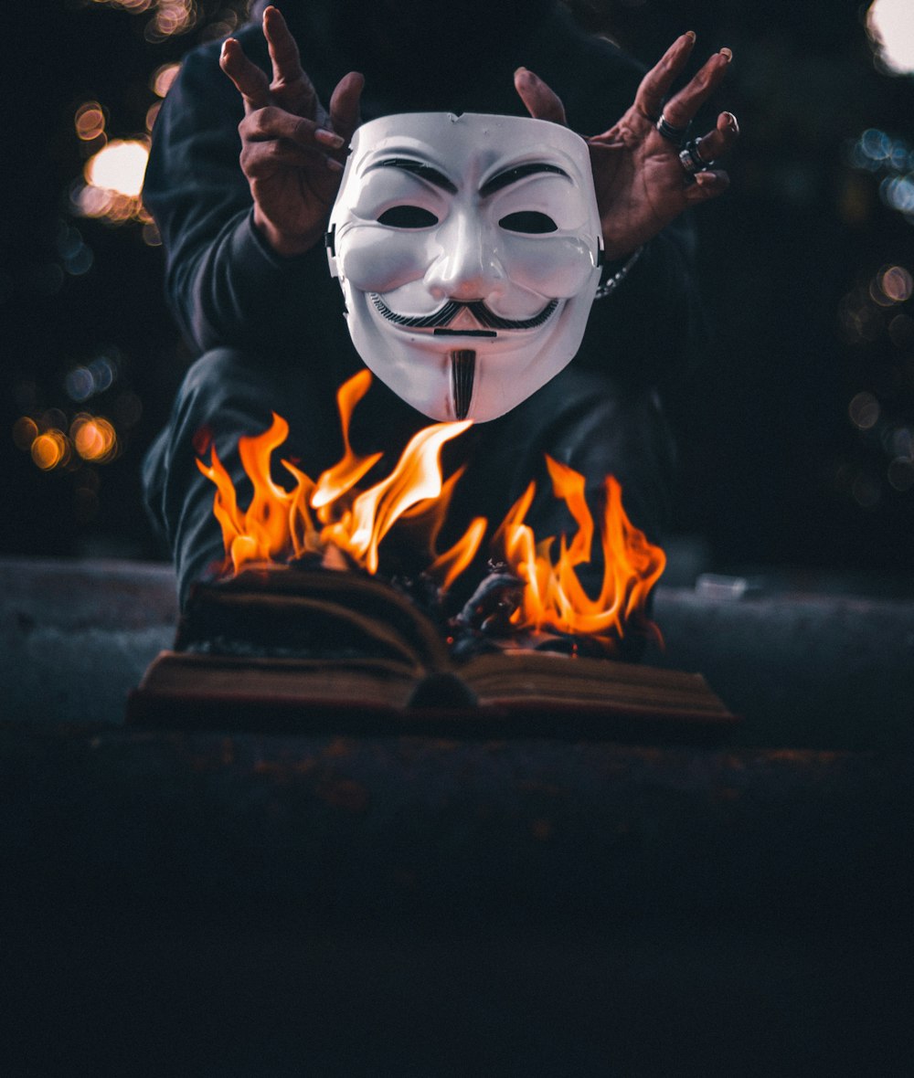 white and black mask with fire