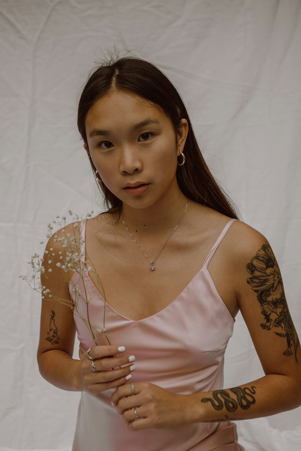 woman in pink tank top wearing gold necklace