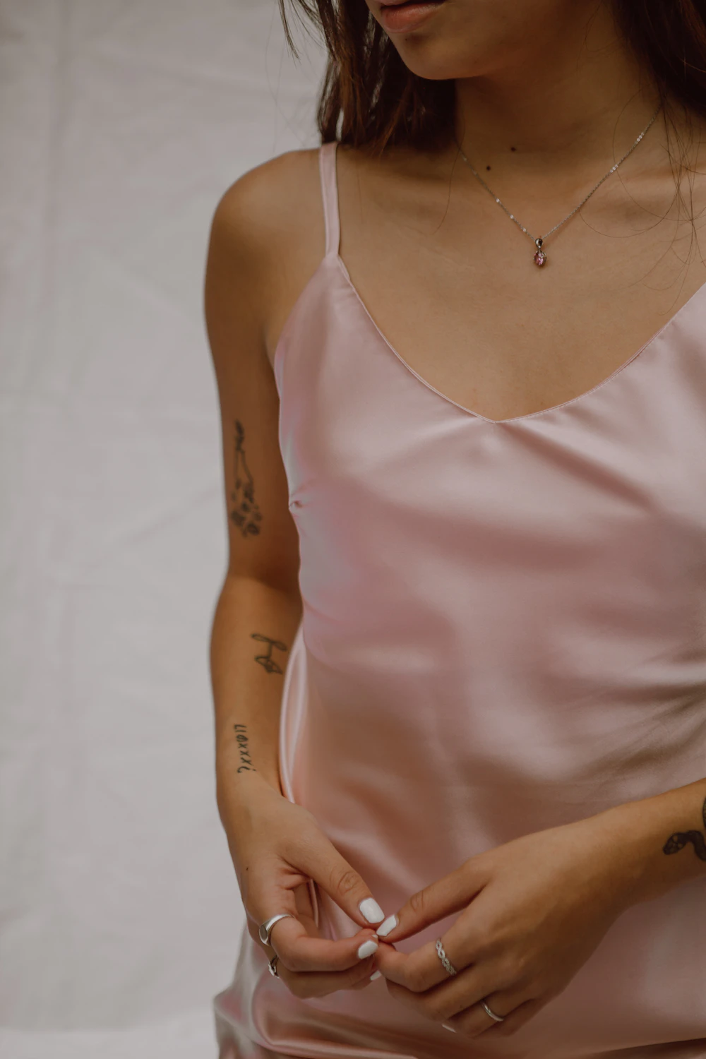 Woman wearing a blush pink silk camisole