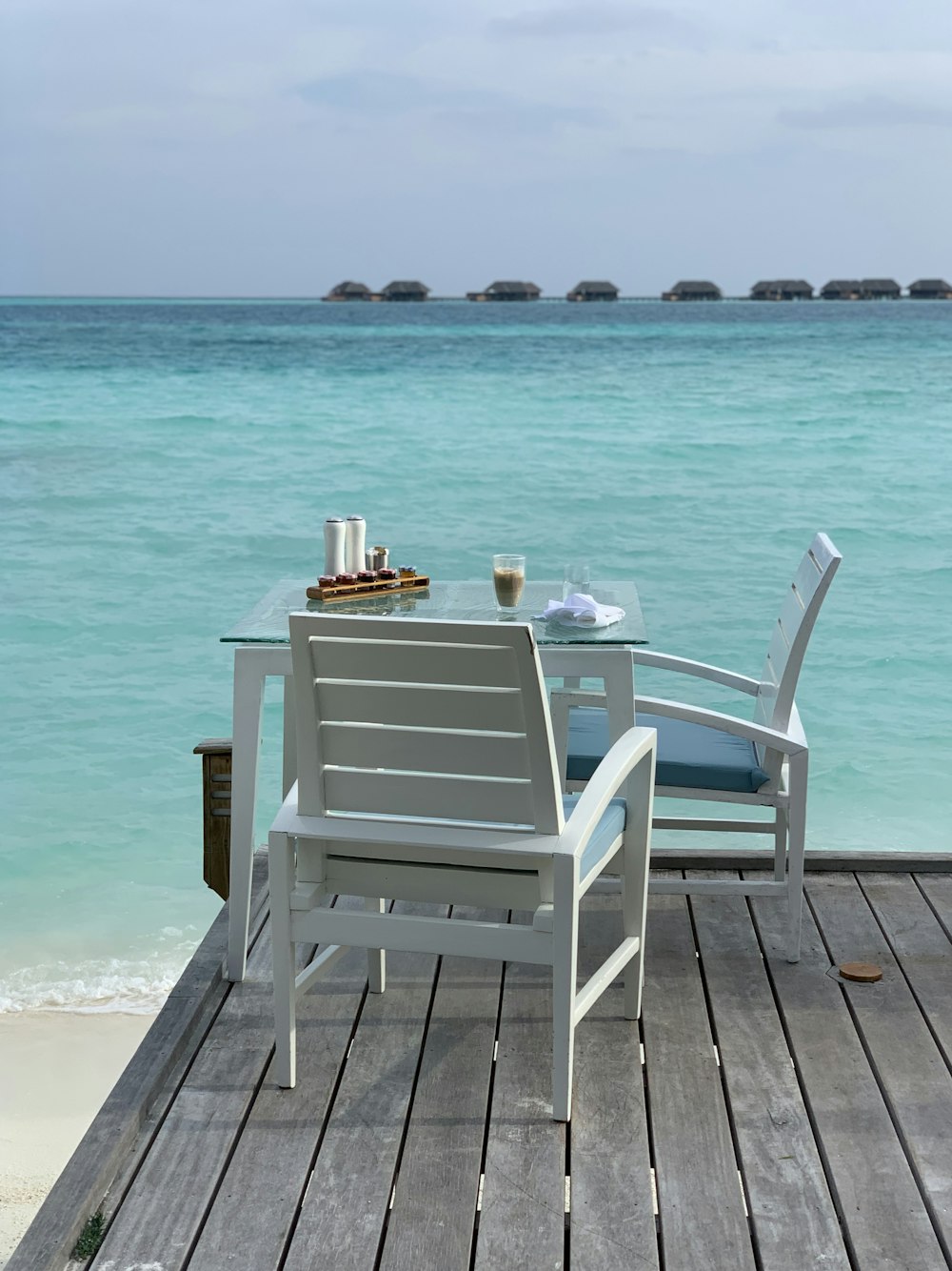 white wooden armchair on beach during daytime