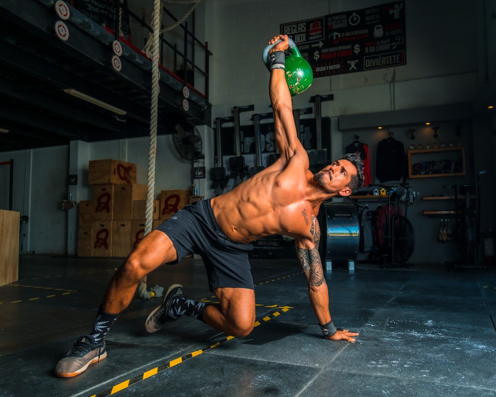 mascular man exercising with a kettlebell