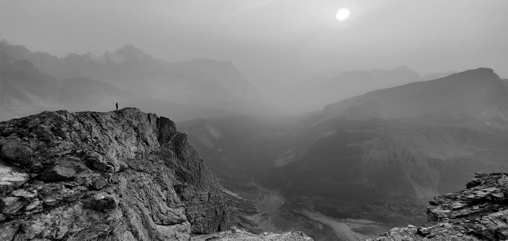 grayscale photo of mountains and clouds