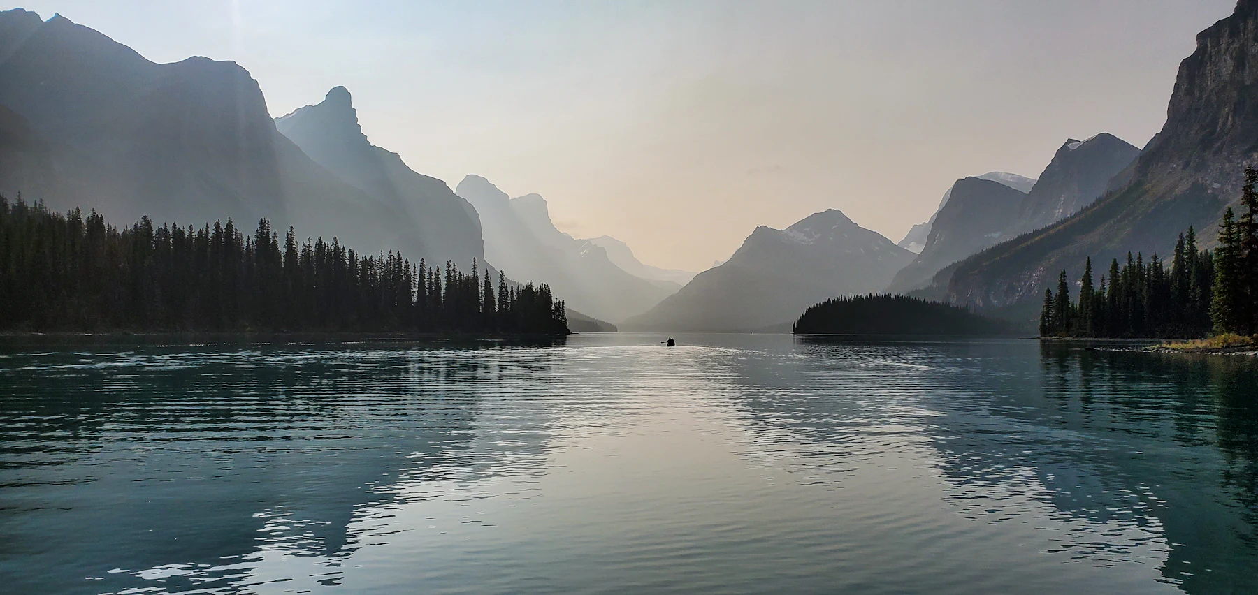 A calm lake below mountains