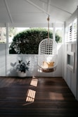 white bird cage on brown wooden floor
