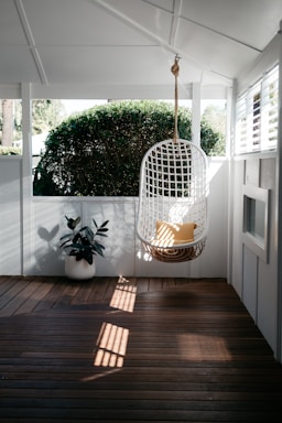 white bird cage on brown wooden floor
