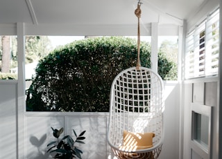 white bird cage on brown wooden floor