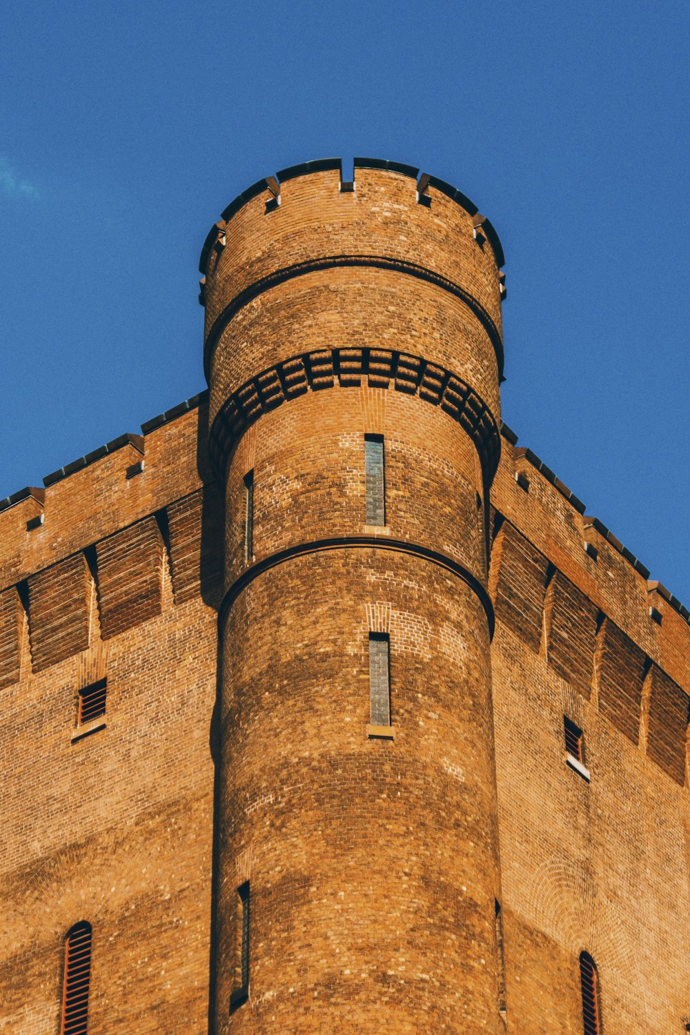 brown brick building under blue sky during daytime