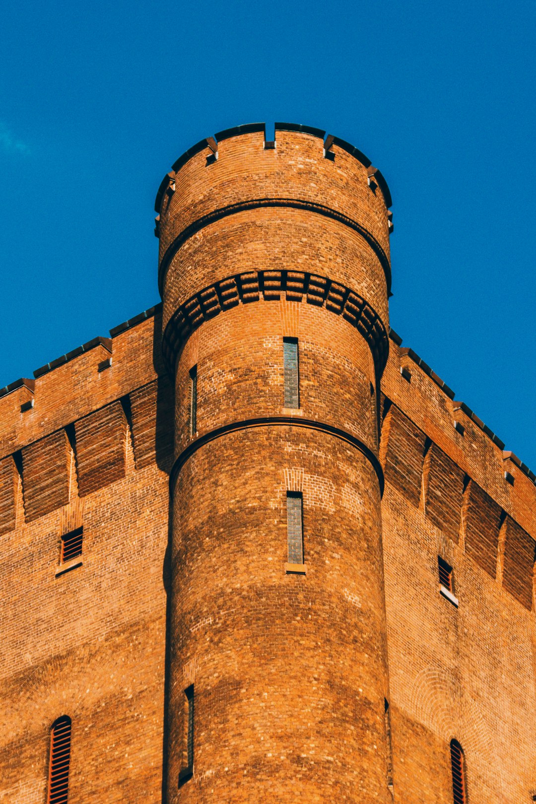 brown brick building under blue sky during daytime