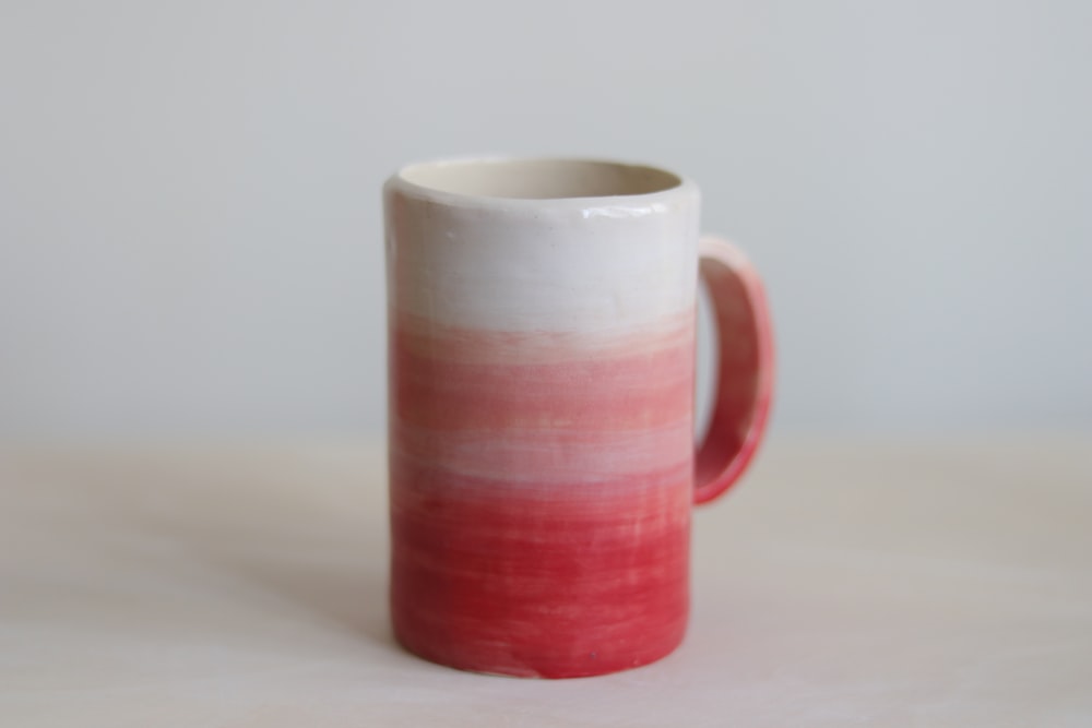 white and pink ceramic mug