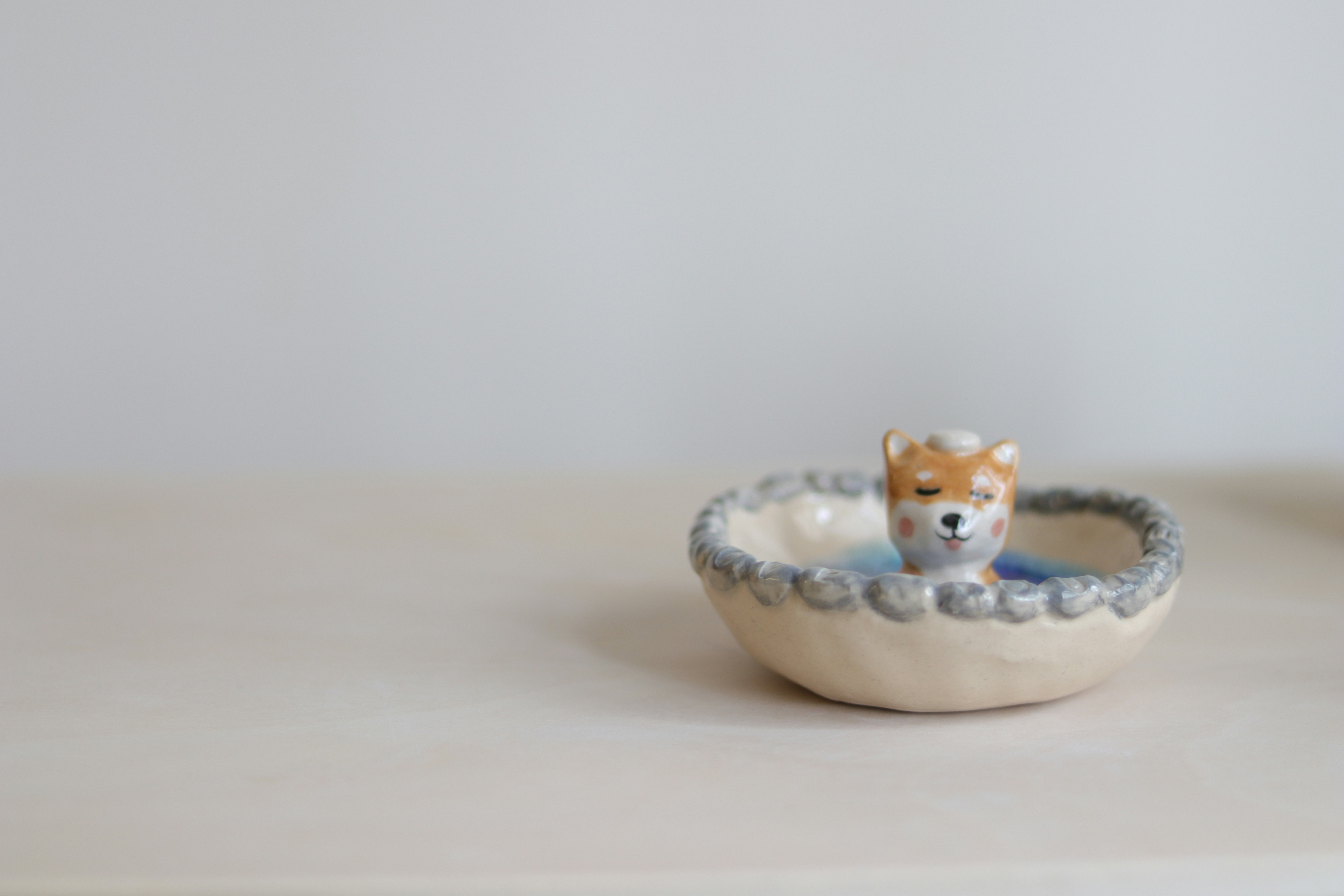 brown and white cat ceramic figurine