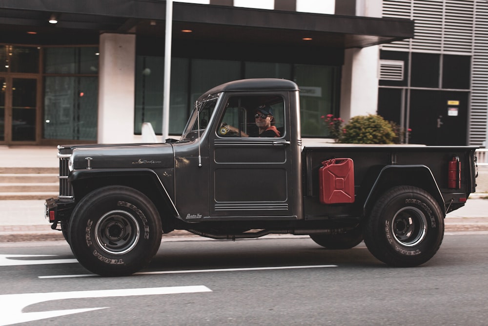 black single cab pickup truck parked near building during daytime