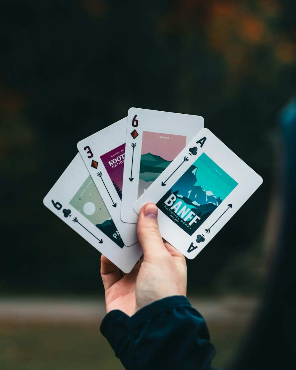 person holding 2 playing cards