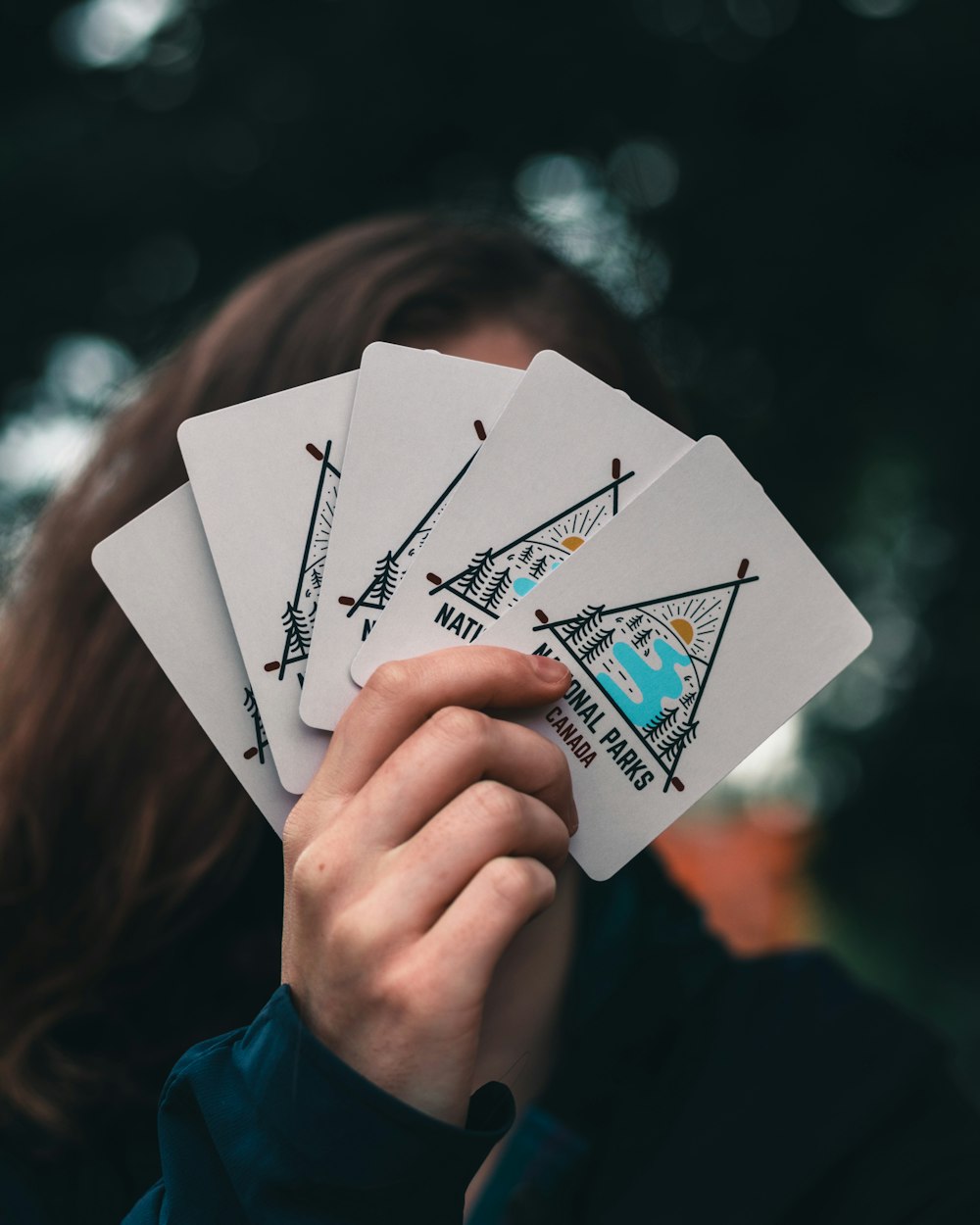 person holding white printer paper with drawing