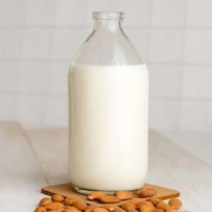 white milk in clear glass bottle