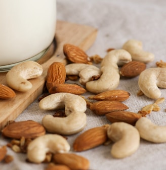 brown almond nuts on white textile