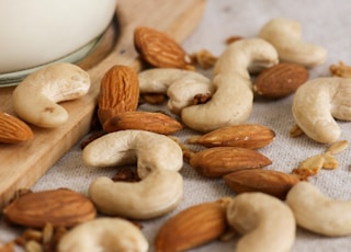 brown almond nuts on white textile