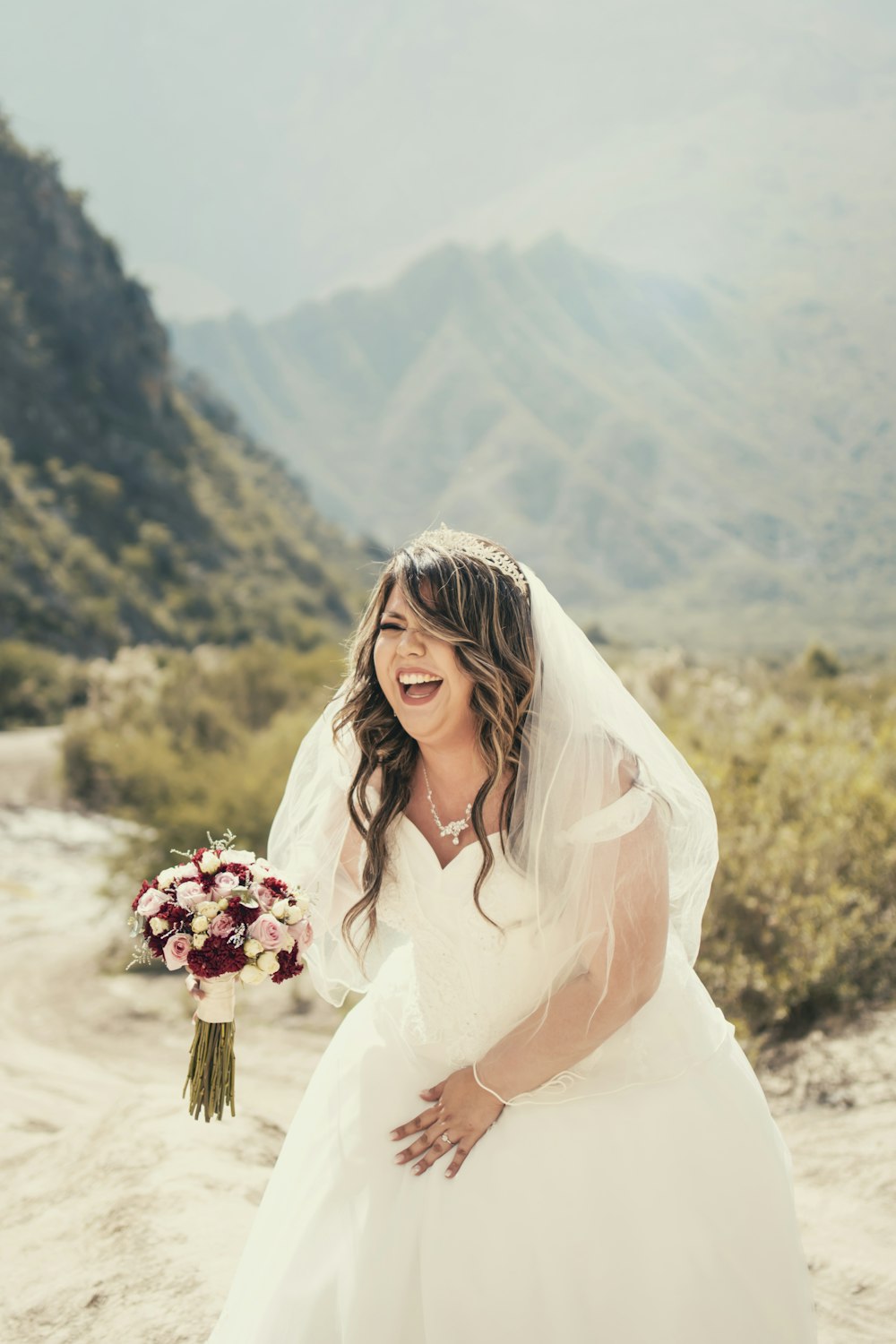 woman in white wedding dress holding bouquet of flowers