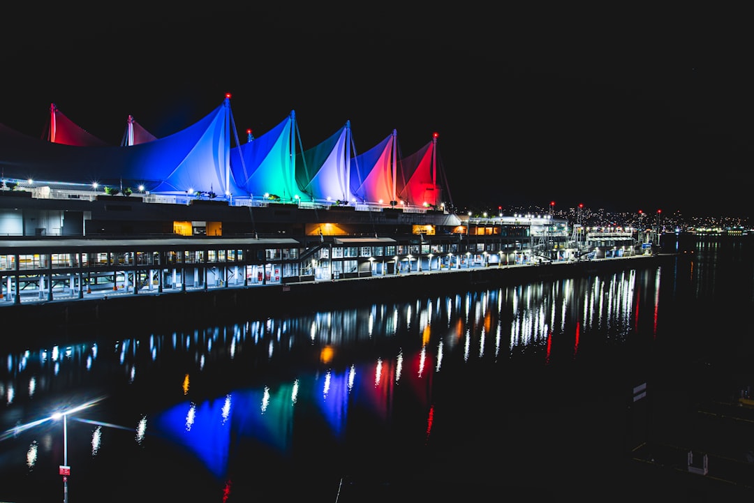 lighted bridge over body of water during night time