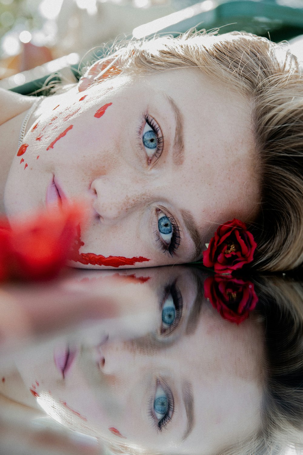 woman with red flower on her ear