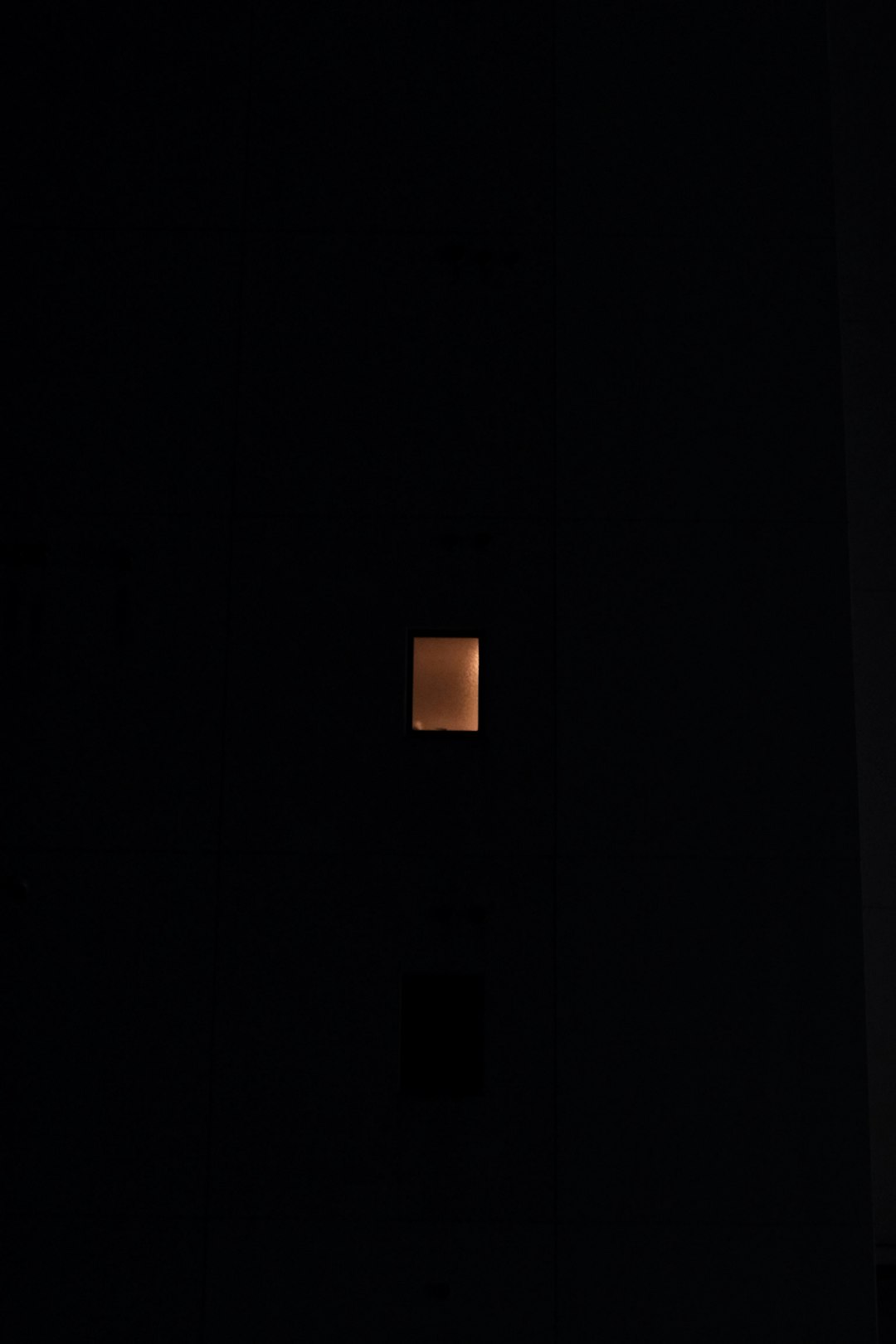white round light turned on in dark room