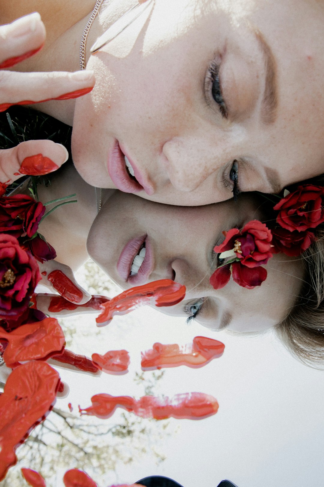woman with red petals on her face