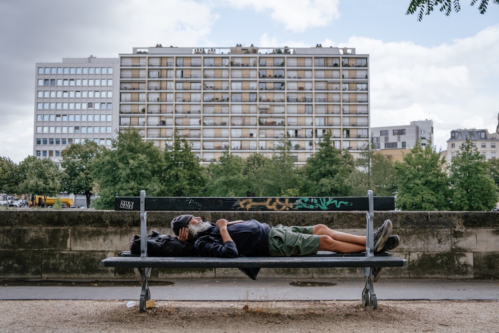 man and woman lying on bench