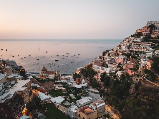 aerial view of city buildings near body of water during daytime in 84017 Positano Italy