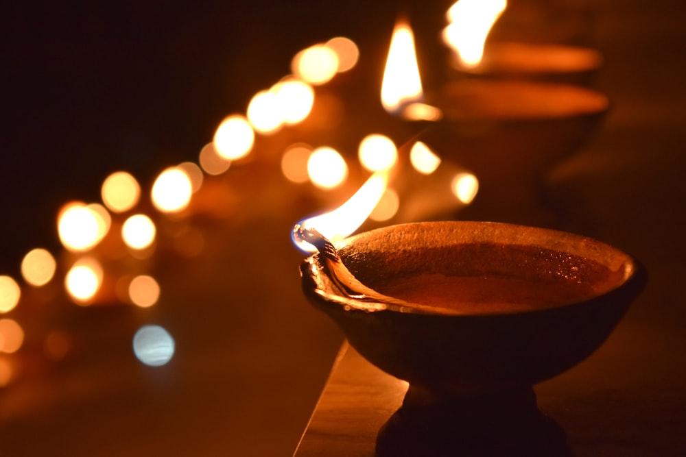 a row of lit candles sitting on top of a table