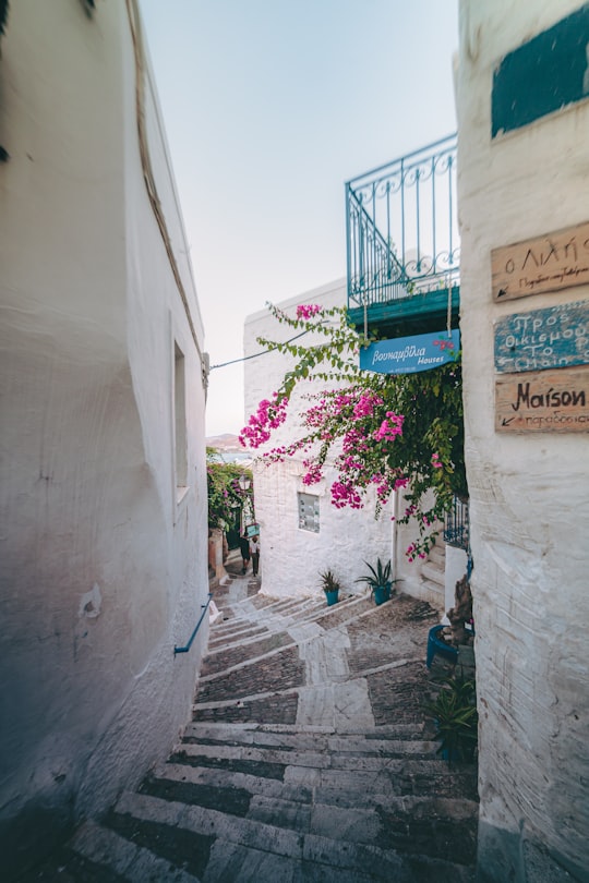 green and white signage on white concrete wall in Syros Greece