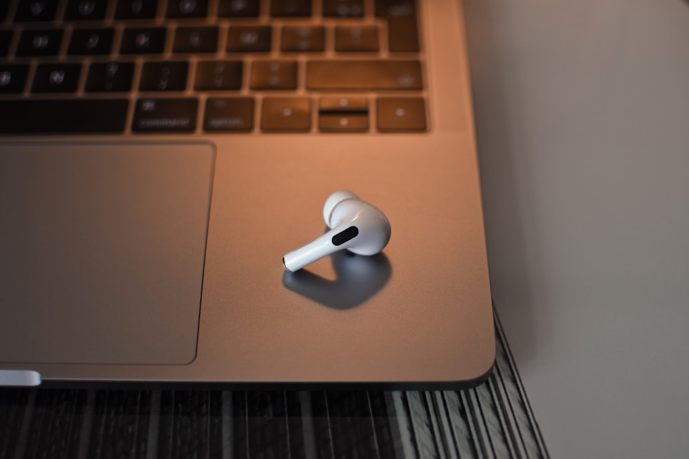 white earbuds on silver macbook