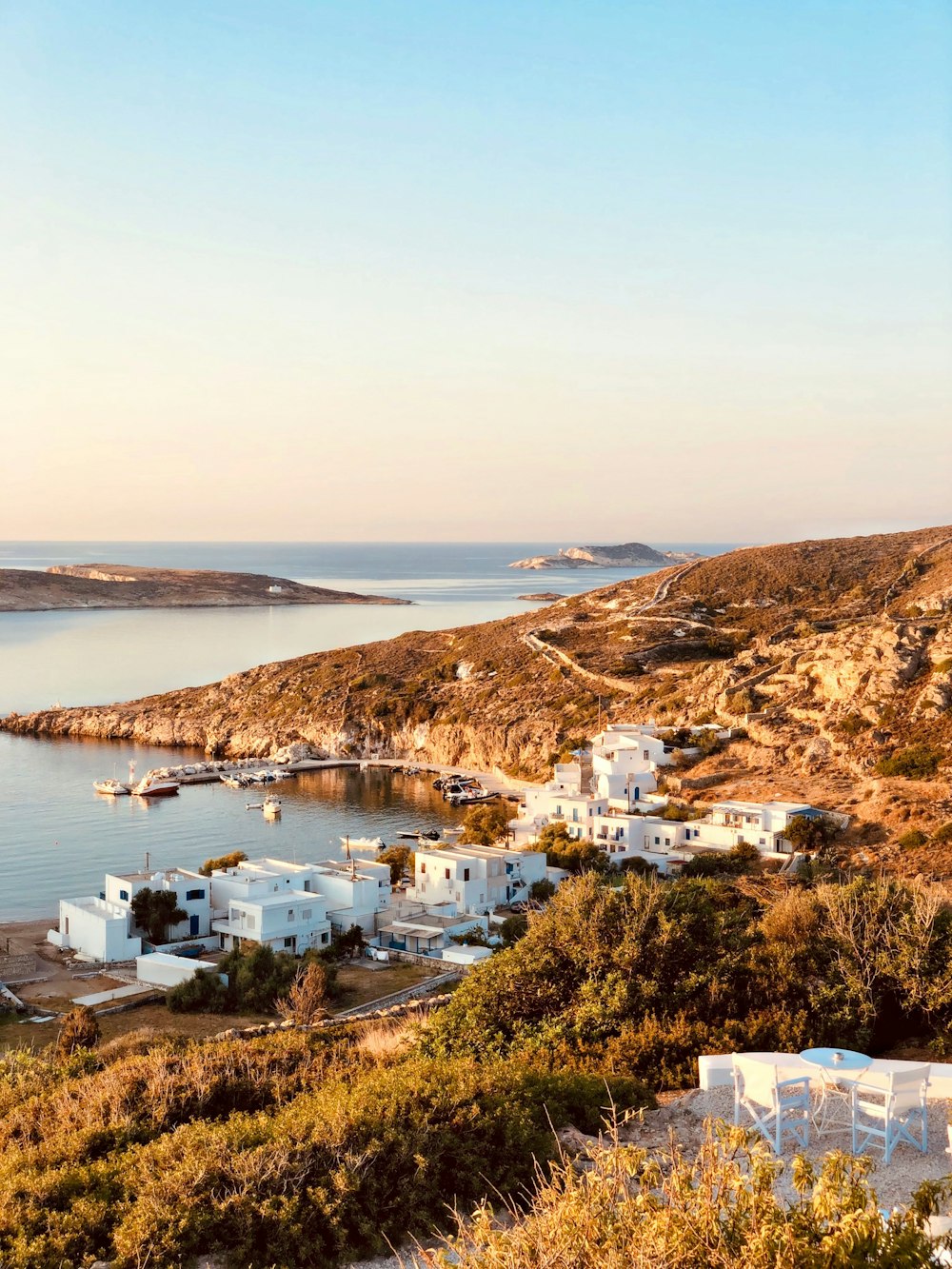 white and brown houses near body of water during daytime