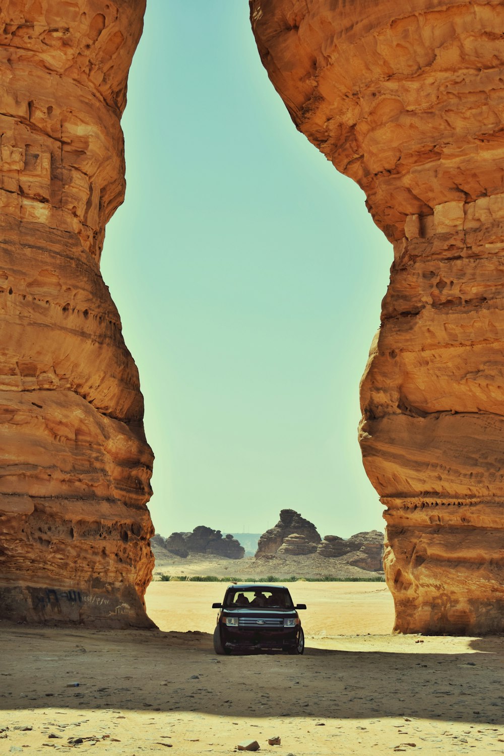 black car on brown rock formation during daytime