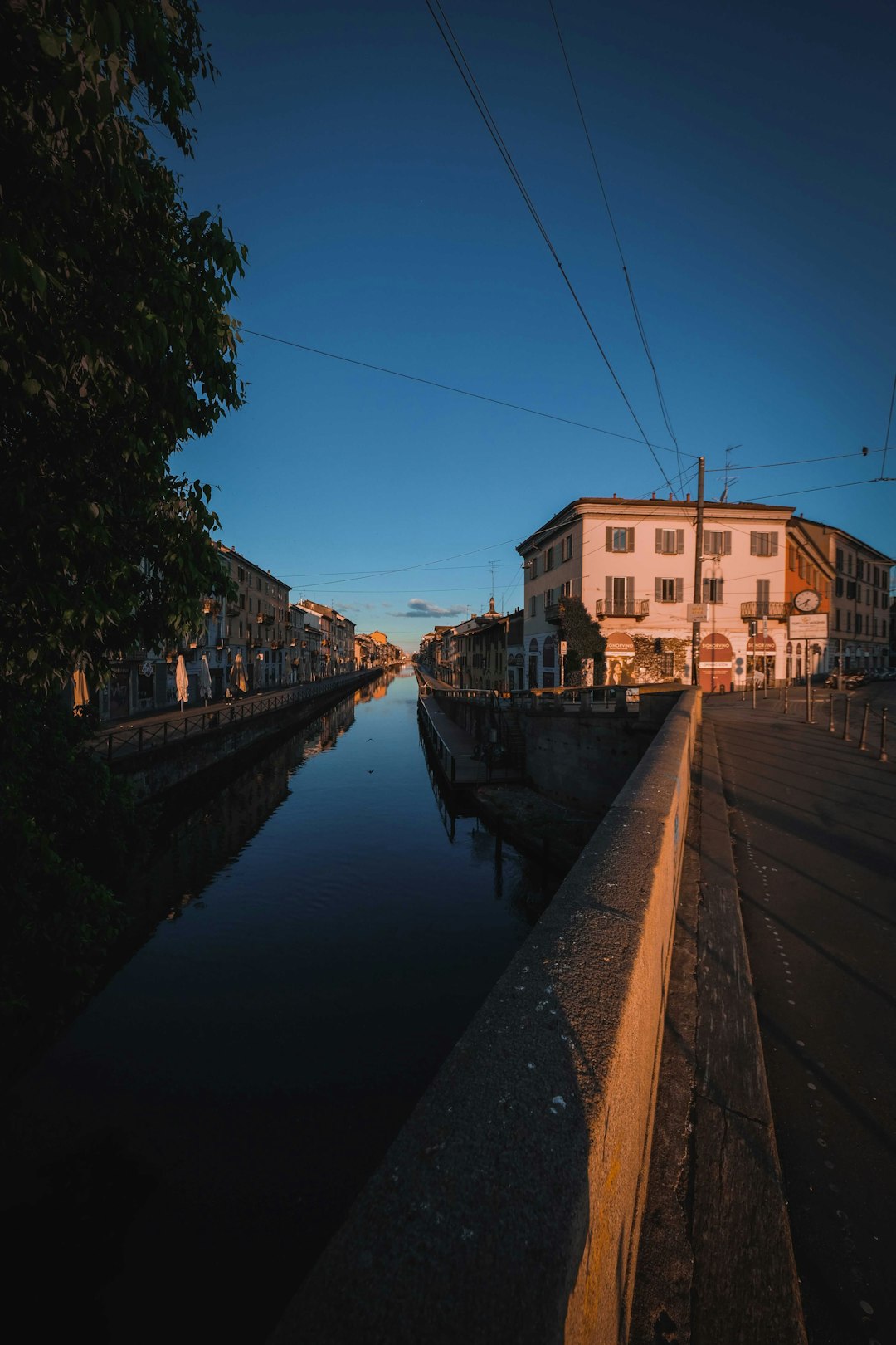 brown concrete building beside river during daytime