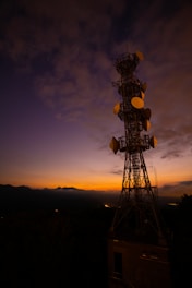 Vintage broadcast tower against a twilight sky, symbolizing early UHF transmissions.