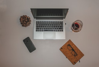 A flat lay of a notebook, glasses, and a tablet showing Pinterest content ideas.