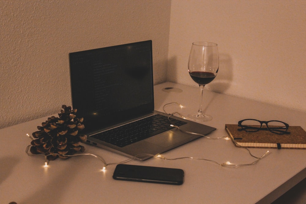 black laptop computer beside black smartphone on white table